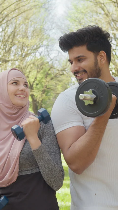 Vertical Screen: Happy young arabian couple in sport clothes having morning Stock Footage 274228339
