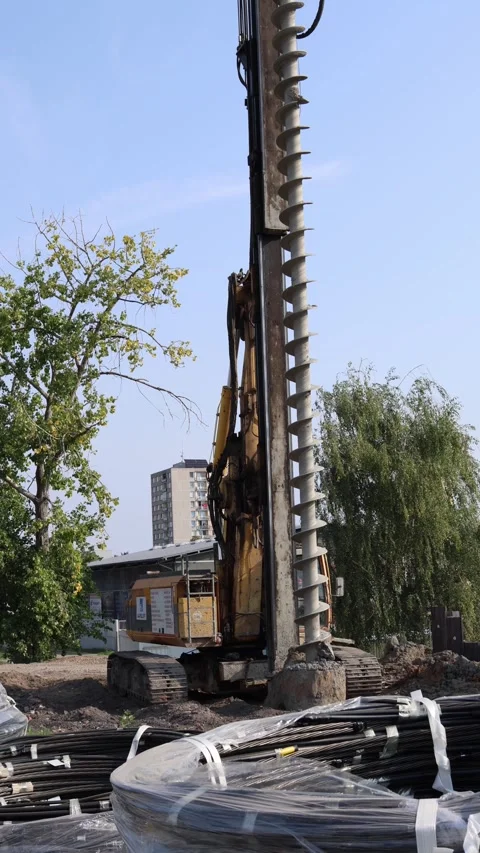 Vertical screen heavy drilling machine with massive auger works at construction  Stock Footage 314979117