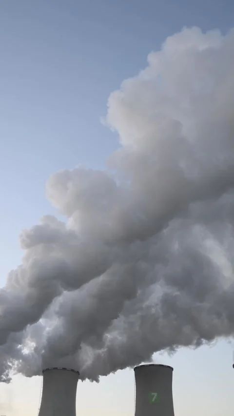 Vertical screen heavy white steam rising from large cooling towers against  Stock Footage 321650780