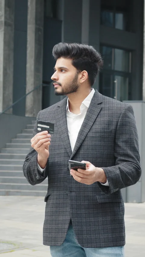 Vertical Screen: Hindu man doing online purchases with mobile and credit card Stock Footage 272787565