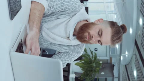Vertical Screen: Hipster employee working on laptop in office Stock Footage 167220533