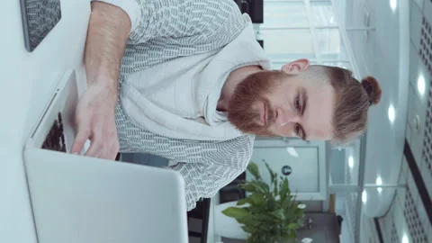 Vertical Screen: Hipster employee working on laptop in office Stock Footage 251461203