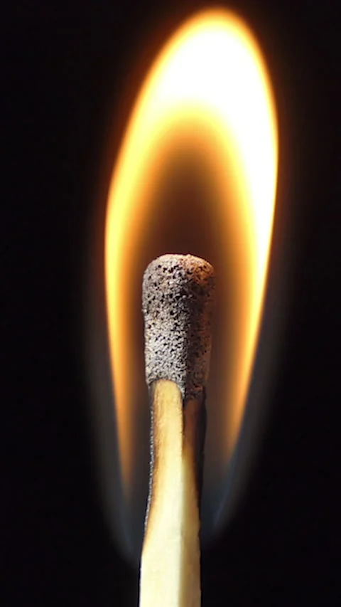 Vertical Screen: Igniting Match and Flame on a Black Background. Slow Motion Stock Footage 232255417