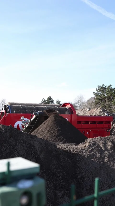 Vertical screen industrial soil processing with a red screening machine  Stock Footage 321650832