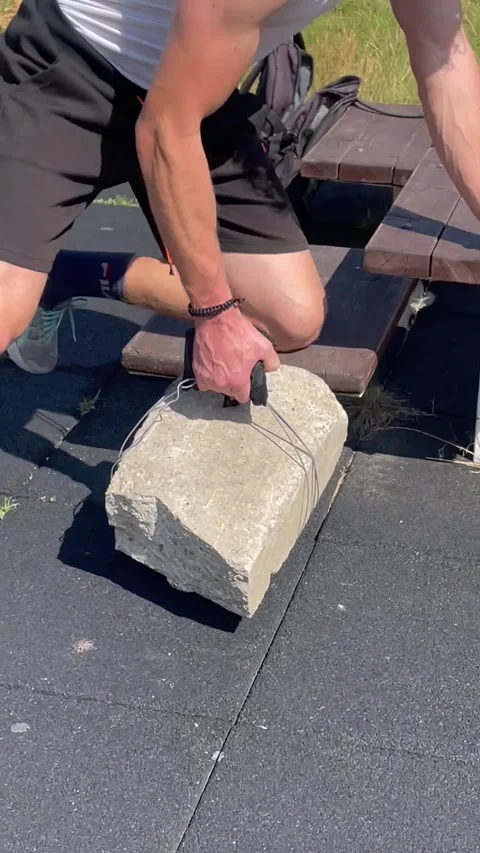 Vertical screen: An intense workout moment as a man performs exercises with an i Stock Footage 296532591