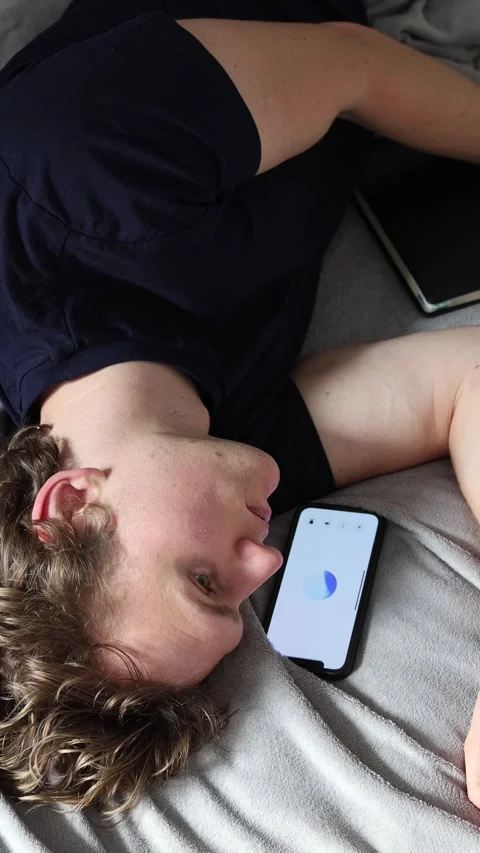 Vertical screen interaction with artificial intelligence young man lies relaxed  Stock Footage 314979543