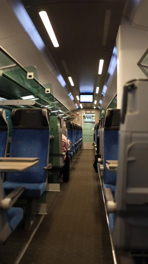 Vertical screen: The interior of a modern train, showcasing rows of comfortable  Stock Footage 300539127