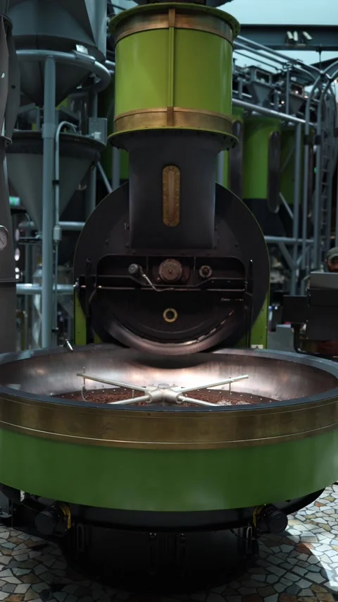 Vertical screen large industrial coffee roaster in action with freshly roasted b Stock Footage 310470318