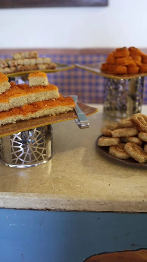 Vertical screen layers of basbousa topped with crisp orange kataifi stacked neat Stock Footage 310012752