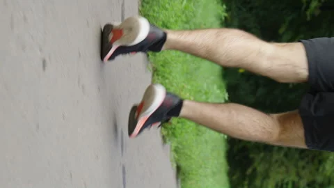 Vertical Screen: Legs of runner on road with marking Stock Footage 247427747