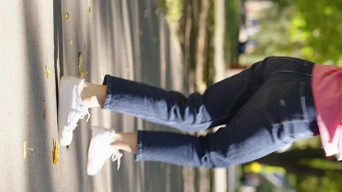 Vertical Screen: Legs of woman dancing on her way in park Stock Footage 166703842