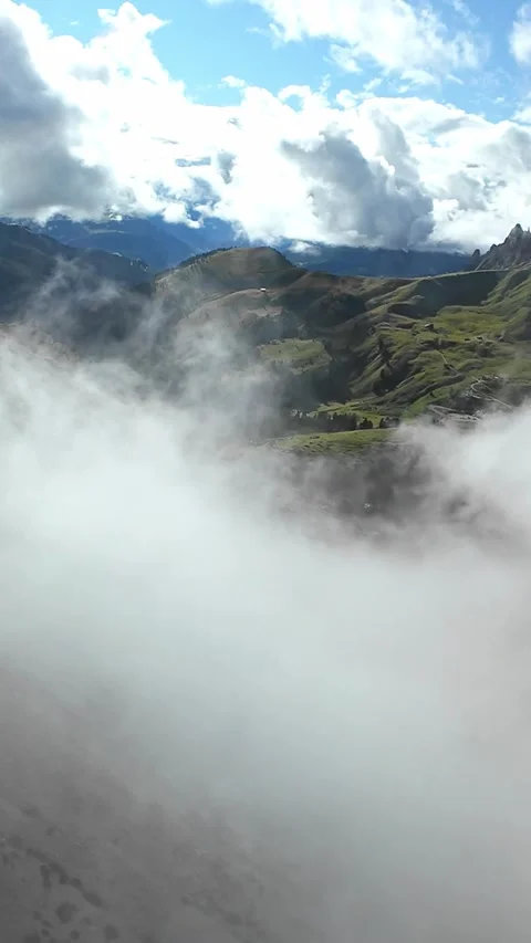 Vertical screen low cloud rolling over scree and ridgeline, landscape Stock Footage 323242962