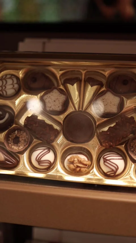 Vertical screen: A luxurious box of assorted chocolates with intricate designs,  Stock Footage 300162224
