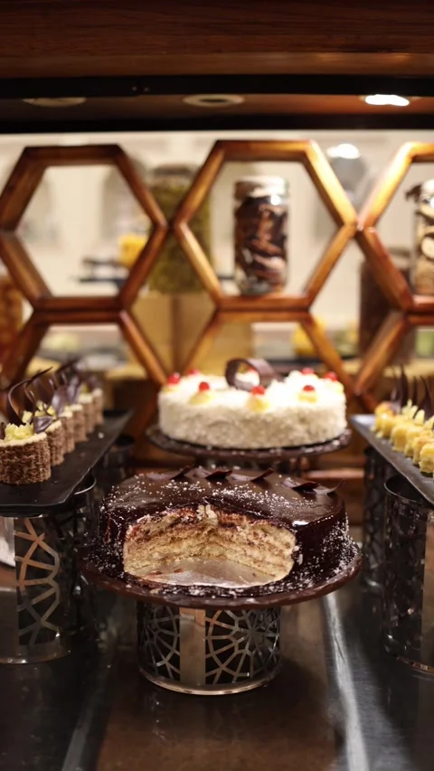 Vertical screen luxurious dessert station with layered chocolate cake creamy whi Stock Footage 310016220