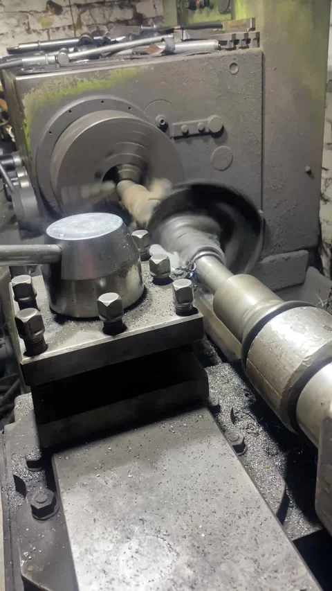 Vertical screen: Machining shaft on lathe. metalworking. Turner working on Stock Footage 263126568