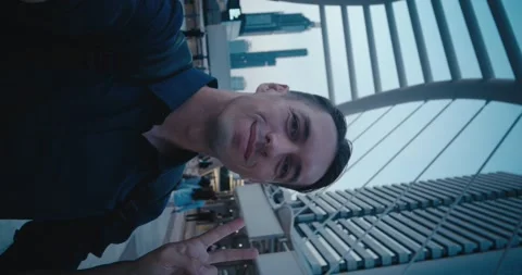 Vertical screen: Man admiring panoramic skyline from futuristic structure Stock Footage 312123011