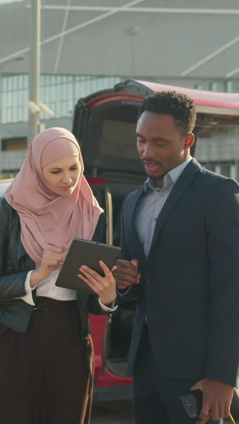 Vertical Screen: Man and muslim woman in hijab standing together outdoors near Stock Footage 274300741