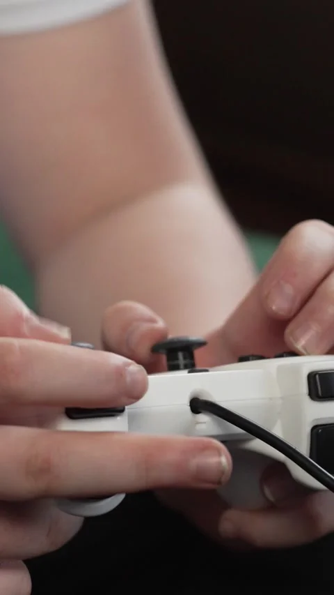 Vertical screen: Man gamer hands holding modern console for play station close Stock Footage 263146893