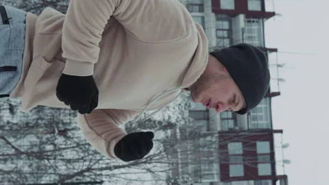 Vertical Screen: Man jogging in winter in slow motion Stock Footage 243416841