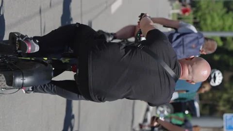 Vertical Screen: Man riding electric bikes in slow motion Stock Footage 223939253