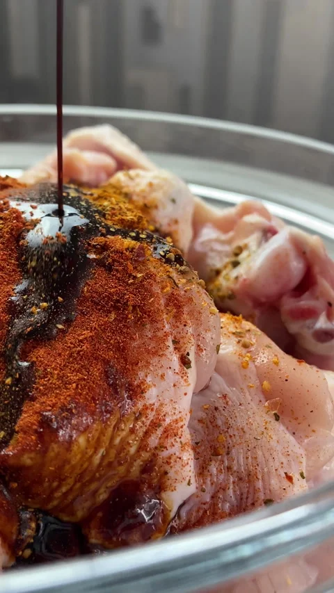 Vertical screen: Marinated chicken wings in sauce in a large dish. Medium plan Stock Footage 238759596