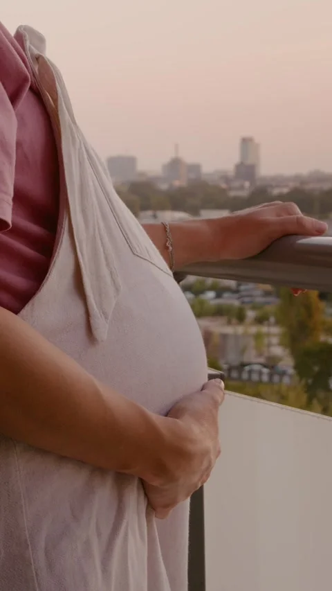 Vertical Screen Medium shot of a pregnant woman on a balcony. Video stock 303491336