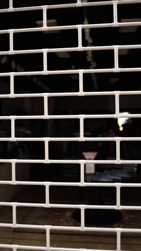 Vertical screen metal security shutter closing retail store at night 動画素材 323265816