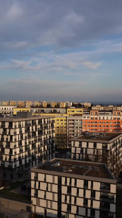 Vertical screen modern apartment buildings under soft evening light colorful fac Stock Footage 306007715