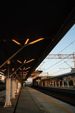 Vertical screen: modern architecture of empty train station platform with Stock Photos