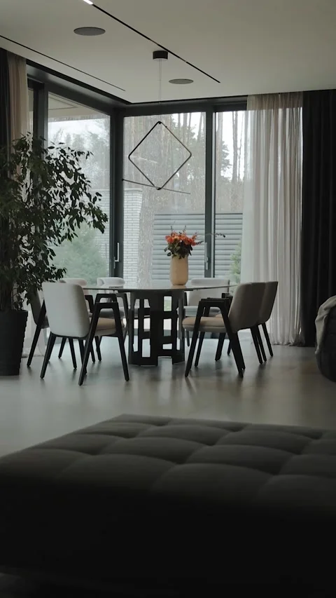 Vertical screen: modern, elegant living room with a dining area that offers Stock Footage 311260017