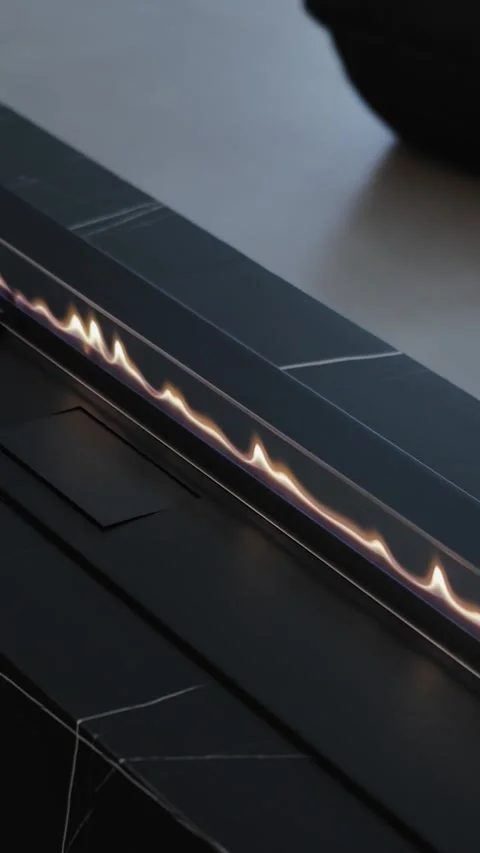 Vertical screen: modern gas fireplace with flame, black marble stone texture in Stock Footage 311253635