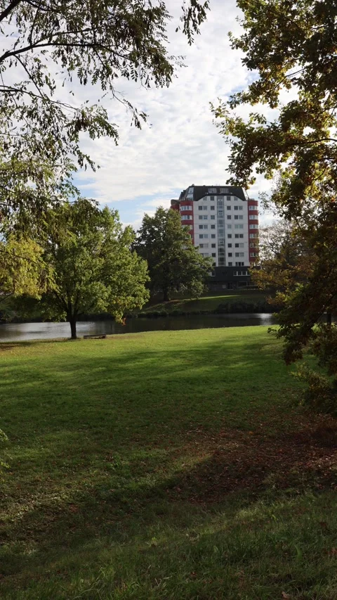 Vertical screen modern luxury apartment building stands near calm river surround Stock Footage 319841782