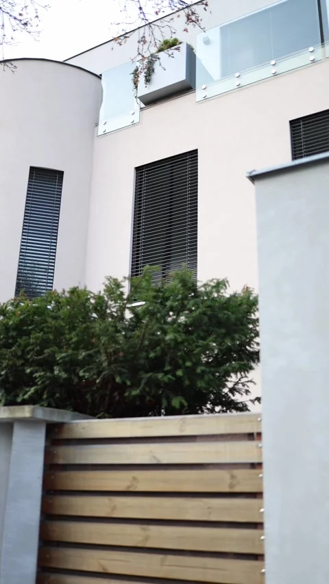 Vertical screen: Modern residential building with rounded corner, vertical windo Stock Footage 304884362