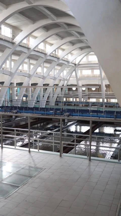 Vertical screen: Modern water treatment plant interior with large white arched b Stock Footage 304883952