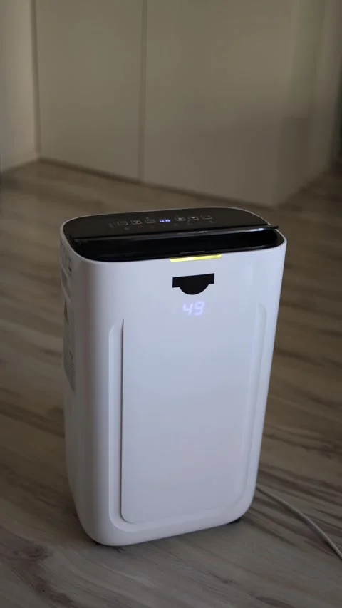 Vertical screen modern white air dehumidifier with glowing digital display worki Stock Footage 318867707