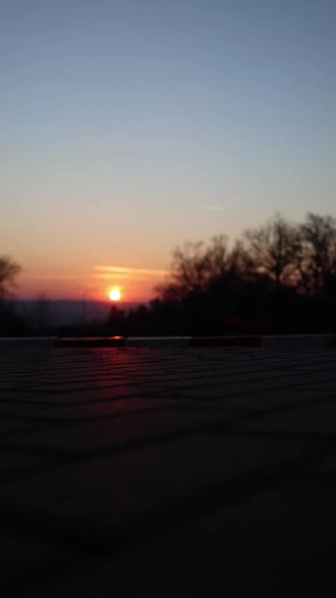 Vertical screen: This is a moment where time feels slower. The setting sun casts Stock Footage 301240080