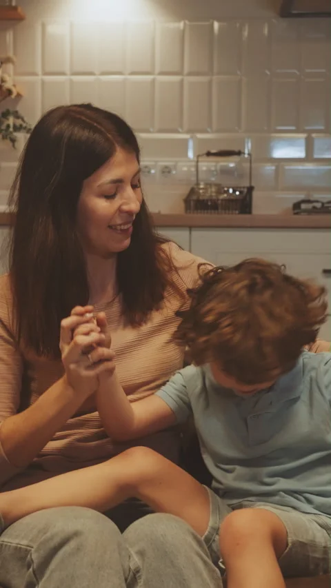 Vertical screen: Mother Enjoying Playtime with Children on Sofa Stock Footage 281660182