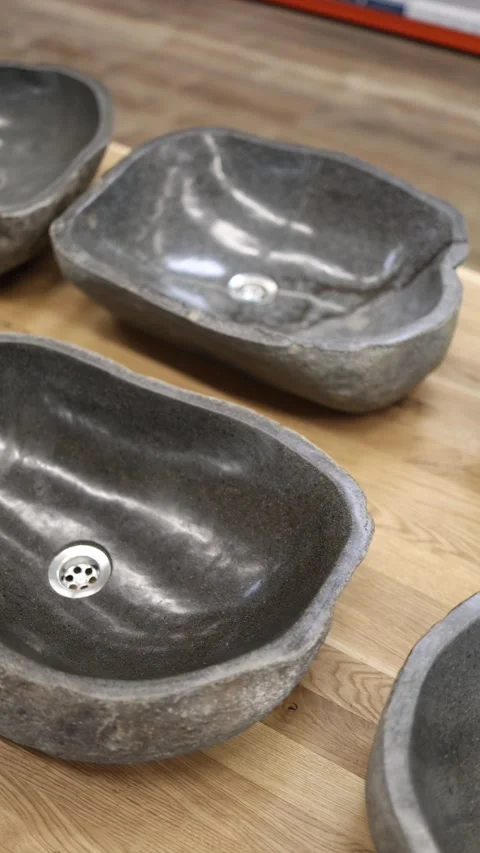 Vertical screen natural stone sinks with raw edges and polished basins stylish b Stock Footage 307142631