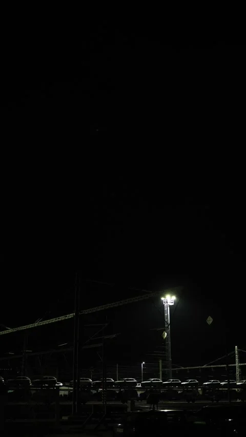 Vertical screen night railway yard with cars on freight train under bright indus Video stock 319242117
