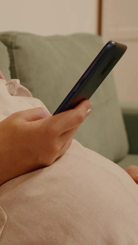 Vertical Screen No face pregnant woman using phone and stroking her tummy. Stock Footage 303493208