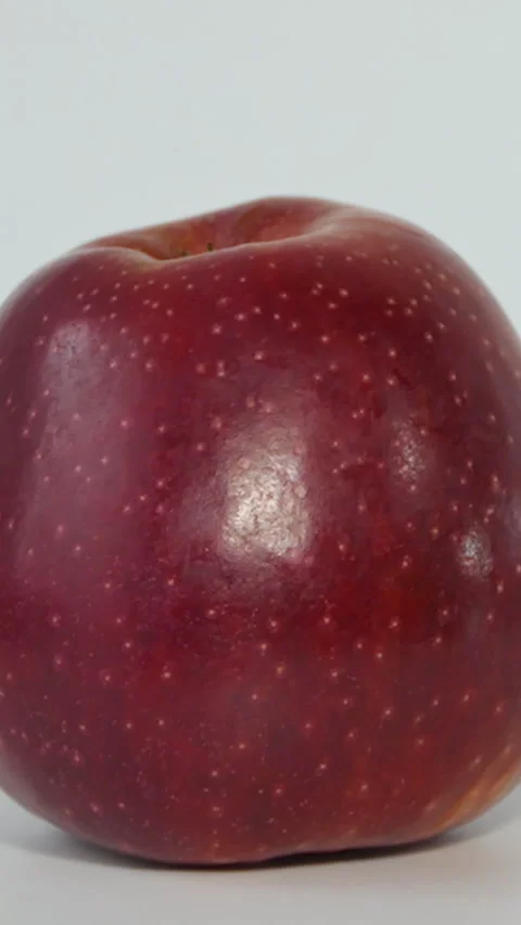 Vertical Screen: One whole red apple rotating. Macro shot of a red apple. An Stock Footage 230166701