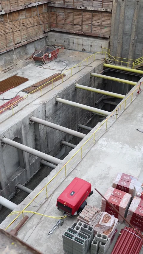 Vertical screen open metro shaft with concrete struts red compressor and stacks  Stock Footage 309541947