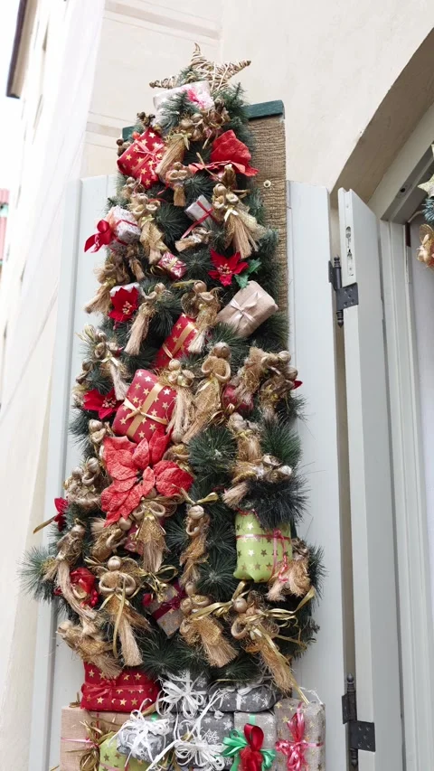 Vertical screen outdoor Christmas tree decorated with gift boxes ribbons and gol Stock Footage 318869292
