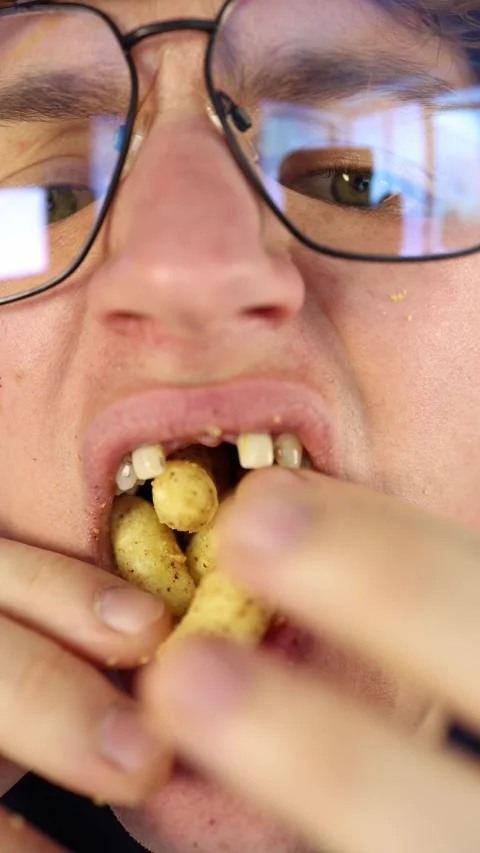 Vertical screen overeating junk food extreme close-up of a mouth stuffed with ch Video stock 312200736