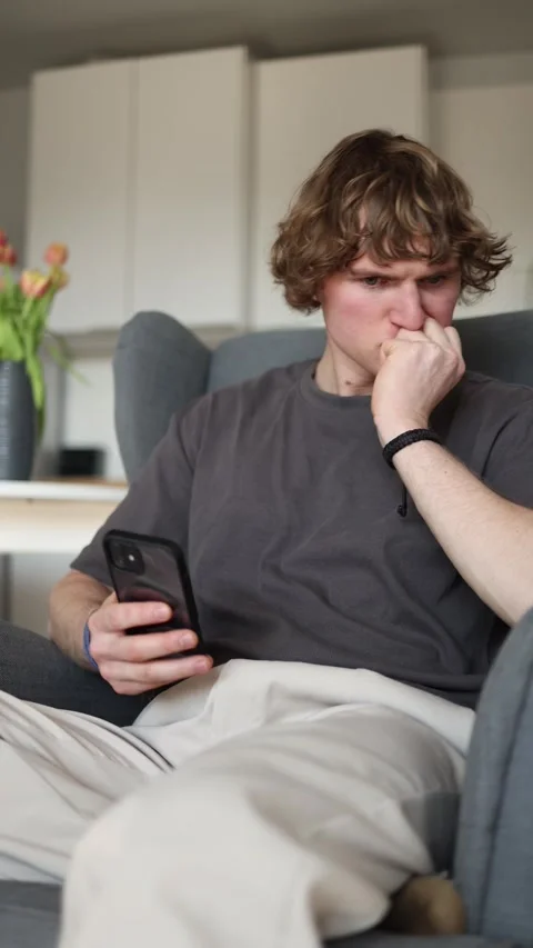 Vertical screen: The person appears focused and absorbed in the information disp Stock Footage 302632900