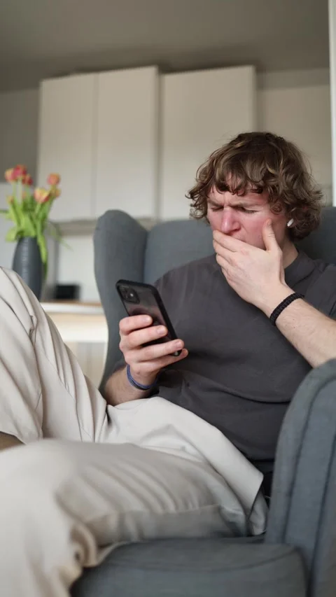 Vertical screen: The person is beginning to fall asleep, looking tired and drows Stock Footage 302632713