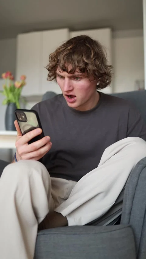 Vertical screen: The person looks alarmed, clearly shocked by what they’re seein Stock Footage 302632797