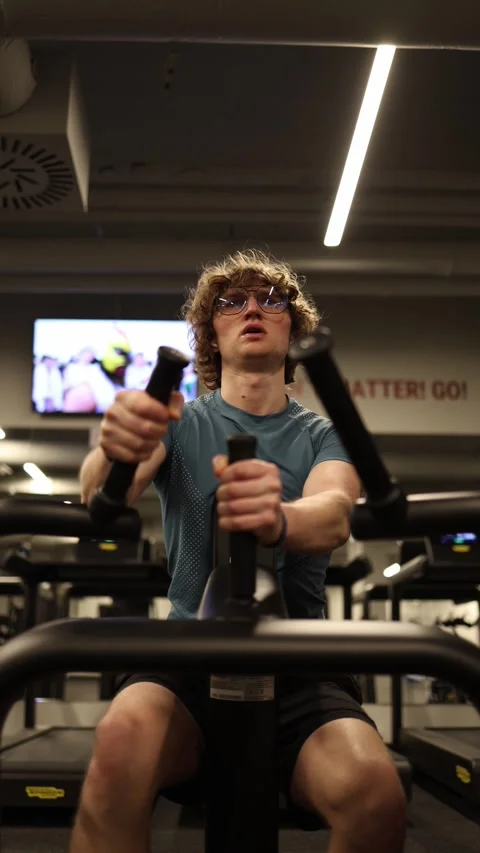 Vertical screen: The person is performing exercises in the gym, focusing on thei Stock Footage 301676808