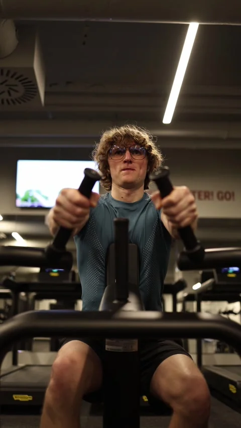 Vertical screen: The person is performing an intense cardio workout with the ell Stock Footage 301676831