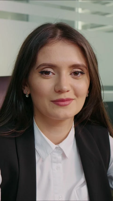 Vertical Screen Portrait of satisfied business woman looking in to camera. Video stock 299983783